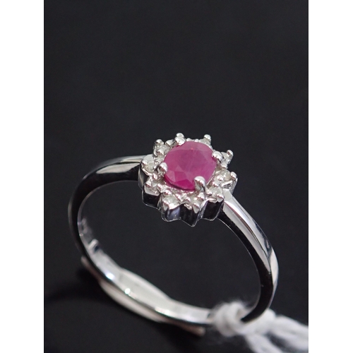 64 - A diamond and ruby ring, showing as finger size L and a half