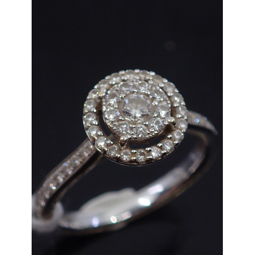 69 - A diamond cluster ring set in 18ct gold. Finger size K