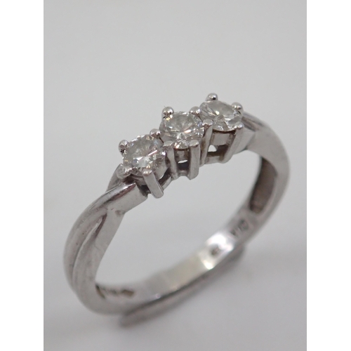 7 - A diamond three stone ring set in platinum finger size L approx. 4 grams