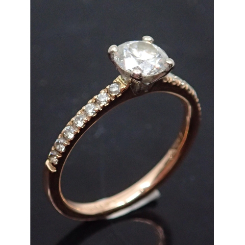 72 - A diamond solitaire ring set with diamond shoulders with a copy of valuation which states the main d... 