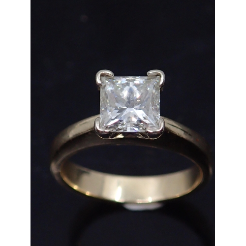 74 - A princess cut diamond solitaire ring set in 14kt gold, with a copy of valuation from C Clarke which... 