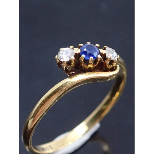 76 - A diamond and sapphire set three stone ring in 18ct gold approx. 2.6 grams, finger size R half