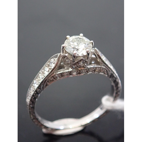 33 - A diamond solitaire ring set with diamond shoulders, total estimated weight of diamonds 0.90cts fing... 