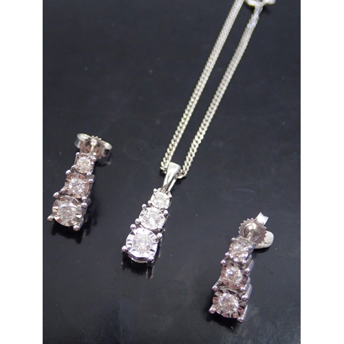 24 - A pair of diamond set earrings and diamond set pendant on chain