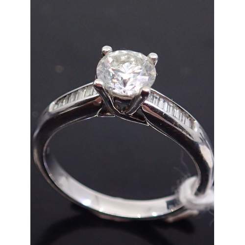 25 - A diamond solitaire ring set with diamond shoulders set in 18ct gold finger size M, estiamted weight... 