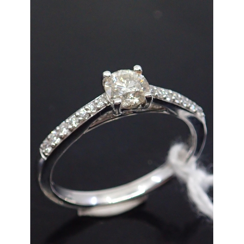 27 - A diamond solitaire ring set with diamond shoulders, total estimated weight of diamonds 0.75cts set ... 