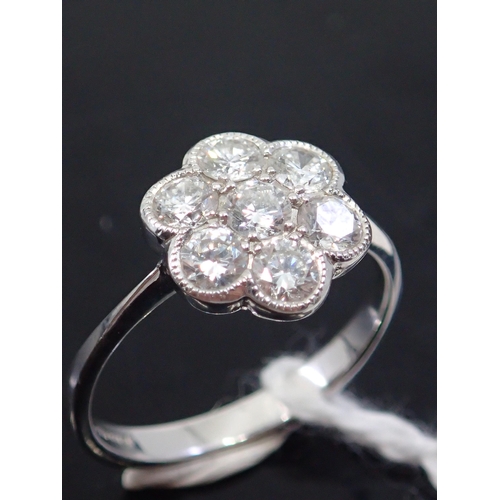 19 - A diamond cluster ring set in 18ct gold, finger size M Half