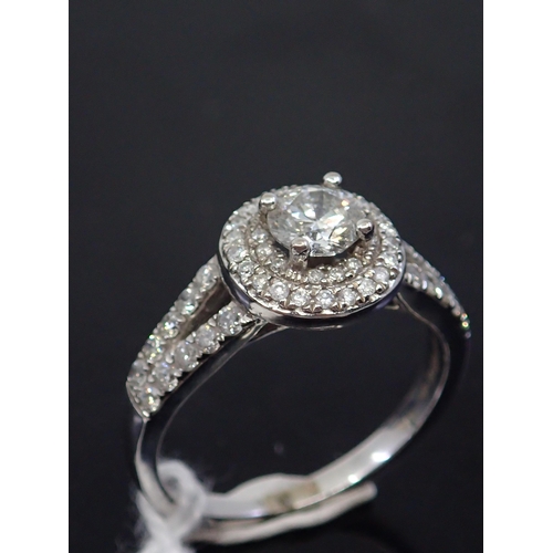 22 - A diamond halo style ring set in 18ct gold , total estimated weight of diamonds 1ct finger size M ha... 