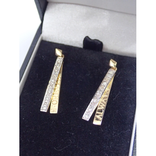 115 - A pair of gold diamond drop earrings