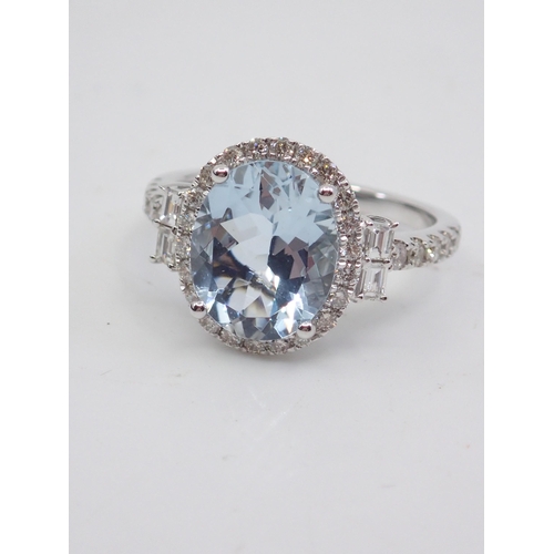 11 - A diamond and aquamarine cluster ring, showing as finger size M and a half