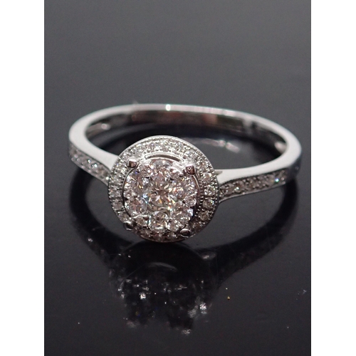 138 - A diamond cluster ring set in 18ct gold