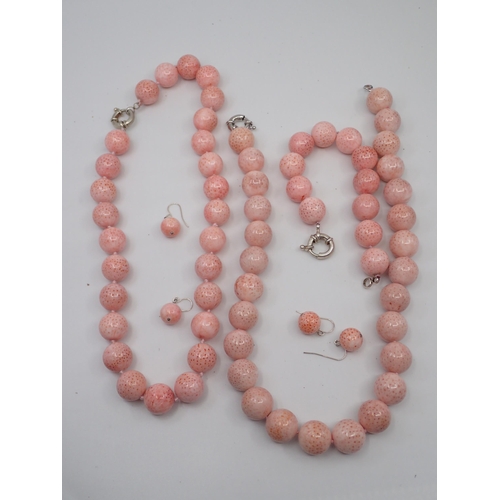 302 - Two pink stone necklaces and a pair of earrings and a bracelet