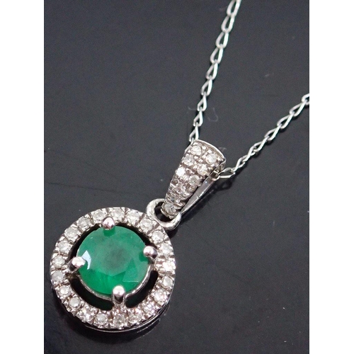 26 - An emerald and diamond cluster pendant on a gold chain (18 inch chain)