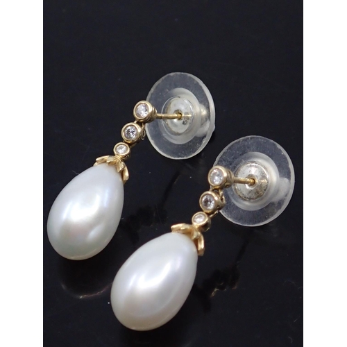 6 - A pair of pearl and diamond earrings