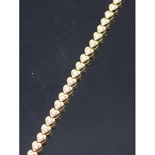 7 - A diamond line bracelet set in 14kt gold approx.11.3 grams 7 inches in length