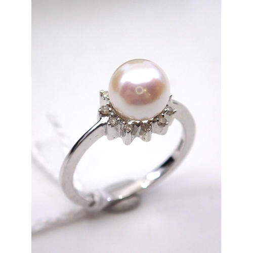 1 - A 9ct white gold diamond and pearl ring. Finger size K 3/4's
