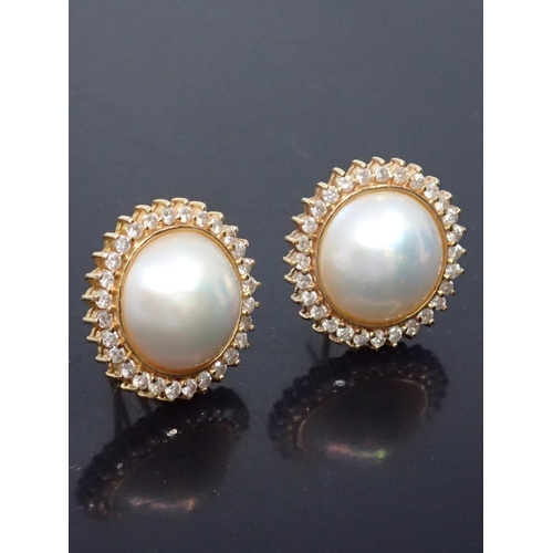 18 - A pair of 14kt gold diamond and mabe pearl earrings approx. 12.8 grams