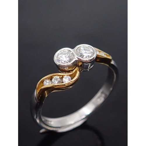 23 - A diamond two stone ring set with diamond shoulders with a copy of an invoice which states the weigh... 