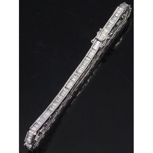 4 - A fine diamond line bracelet (Baguette cut diamonds) total estimated weight of diamonds 4.95cts set ... 