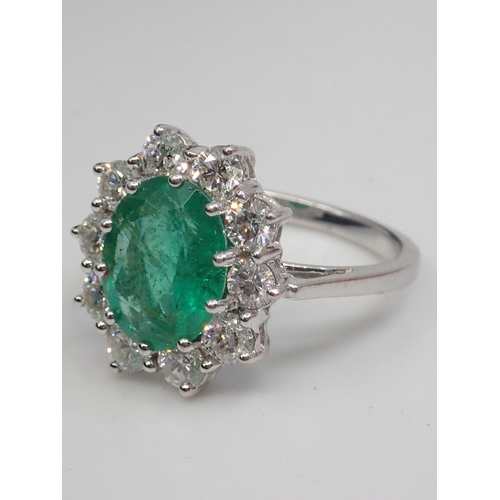 61 - An emerald and diamond cluster ring set in 18ct gold, estimated weight of emerald 2.60cts and total ... 