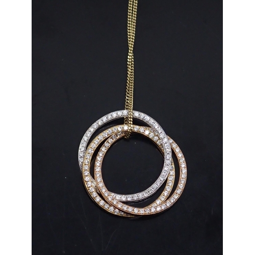 66 - An 18ct gold diamond set triple gold pendant