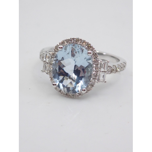 7 - A diamond and aquamarine cluster ring, showing as finger size M and a half