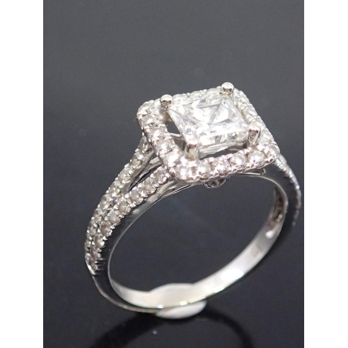8 - A diamond cluster ring, the princess cut diamond to a diamond surround and shoulders mounted in 14ct... 