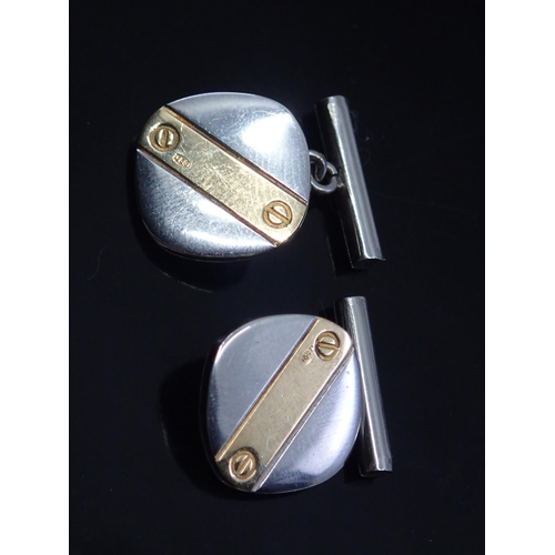 80 - A pair of steel cufflinks set with 18ct gold