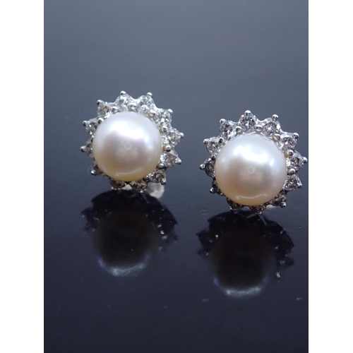 14 - A pair of 18ct gold pearl and diamond set earrings, approx. 7.7 grams
