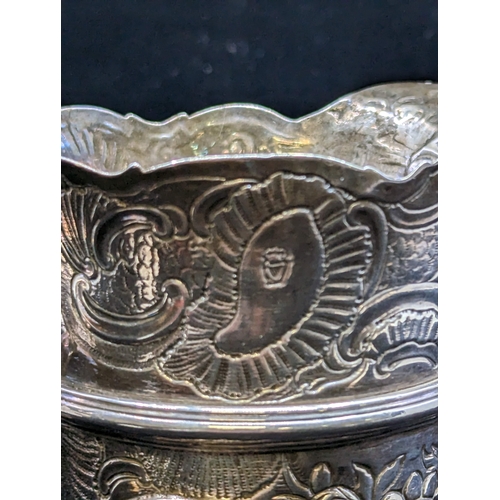 65 - AN IRISH GEORGE III SILVER CREAM JUG, Dublin c.1760/70's, with wavy rim and all-over repousse, chase... 