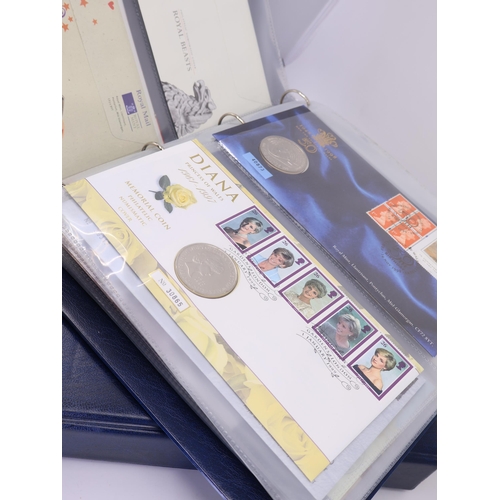 519 - A folder of first day covers with coins