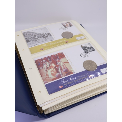 520 - A folder of first day covers with coins