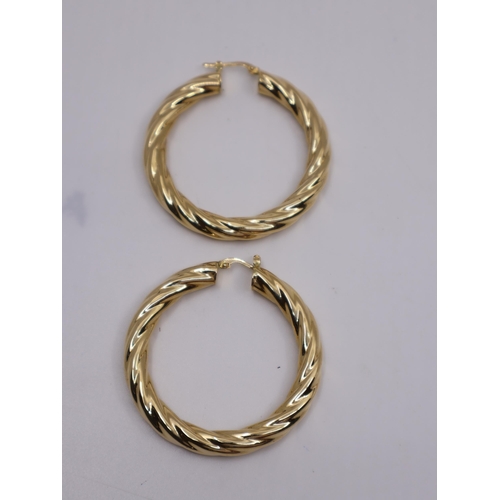 84 - A pair of 18ct gold hoop earrings