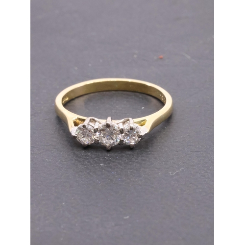 128 - A diamond three stone ring set in 18ct gold, finger size P approx. 3.1 grams