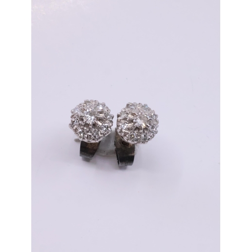 74 - A pair of diamond cluster earrings