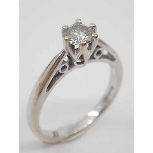 12 - A diamond solitaire ring set in 9ct gold, showing as finger size N