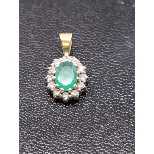 147 - An emerald and diamond cluster pendant