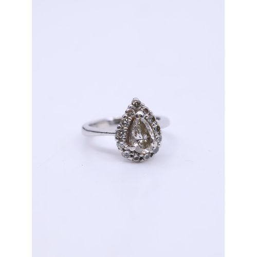 176 - A platinum halo ring set with a pear shape diamond, and a copy of a valuation from Rock jewellers wh... 