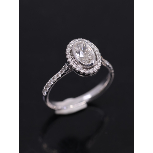 179 - A fine diamond oval cut diamond cluster ring, with a HRD cert which states its 0.71cts F colour VVS2... 