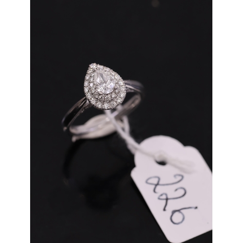 226 - A diamond cluster ring, set in 18ct white gold, showing as finger size H a half