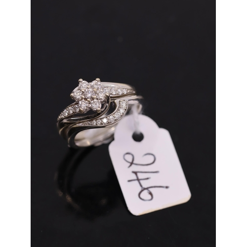 246 - A white gold diamond cluster ring and a twisted diamond band ring, showing as finger size N