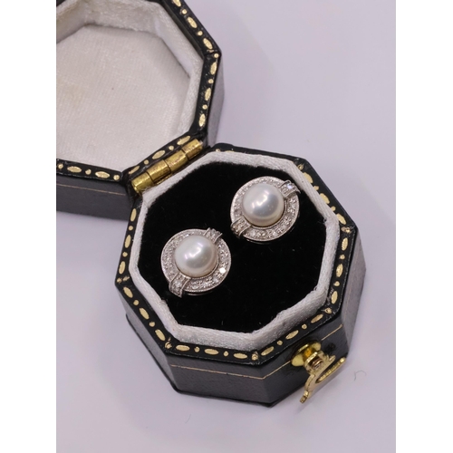 33 - A pair of diamond and pearl cluster earrings set in 9ct gold