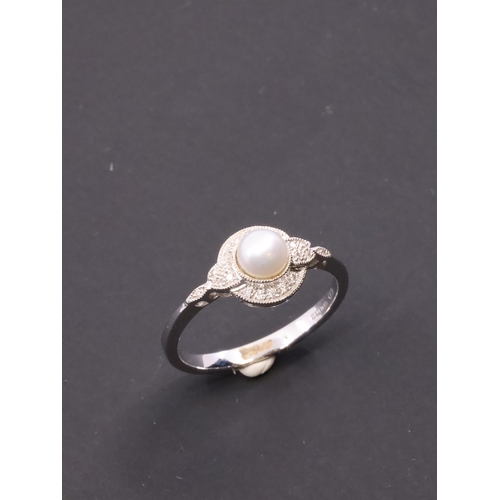 34 - A diamond and pearl cluster ring set in 9ct gold finger size M Half