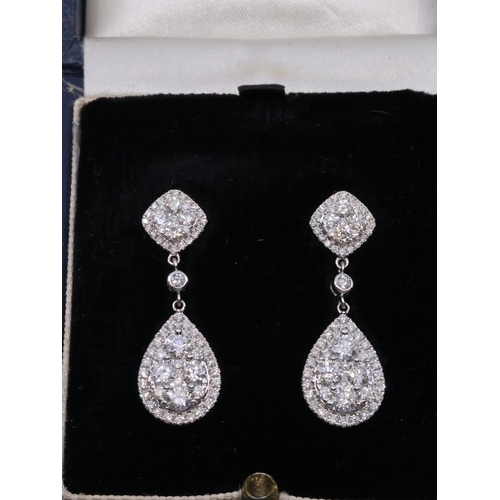 49 - A pair of diamond cluster earrings