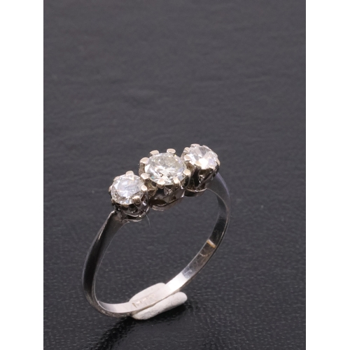 60 - A diamond three stone ring set in 18ct gold, finger size Q approx. 3.1 grams