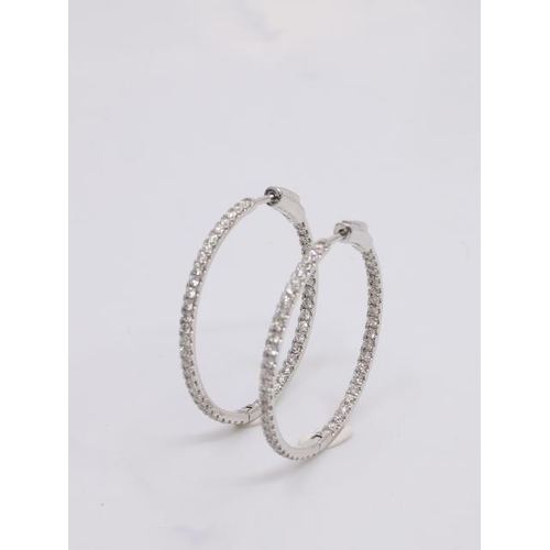 19 - A pair of diamond set hoop earrings set in 18ct gold approx. 3 cm diameter, total estimate weight of... 