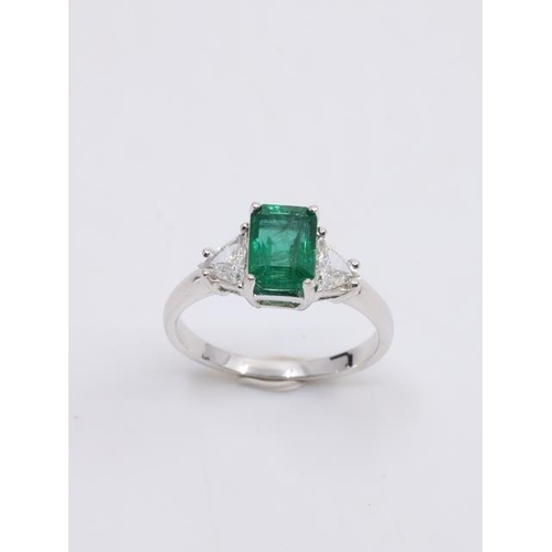 21 - An emerald and diamond three stone ring finger size N