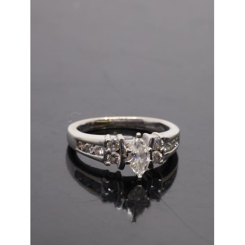 33 - A diamond solitaire ring set with diamond shoulders in 14kt gold finger size J Half