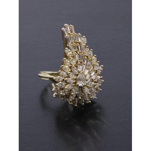 36 - An impressive diamond cocktail cluster ring set in finger size N containing pear shape, baguette cut... 