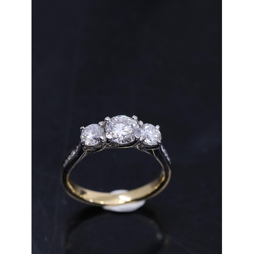 52 - A lab grown diamond three stone ring set in 18ct gold with platinum collet, with an IGI certificate ... 